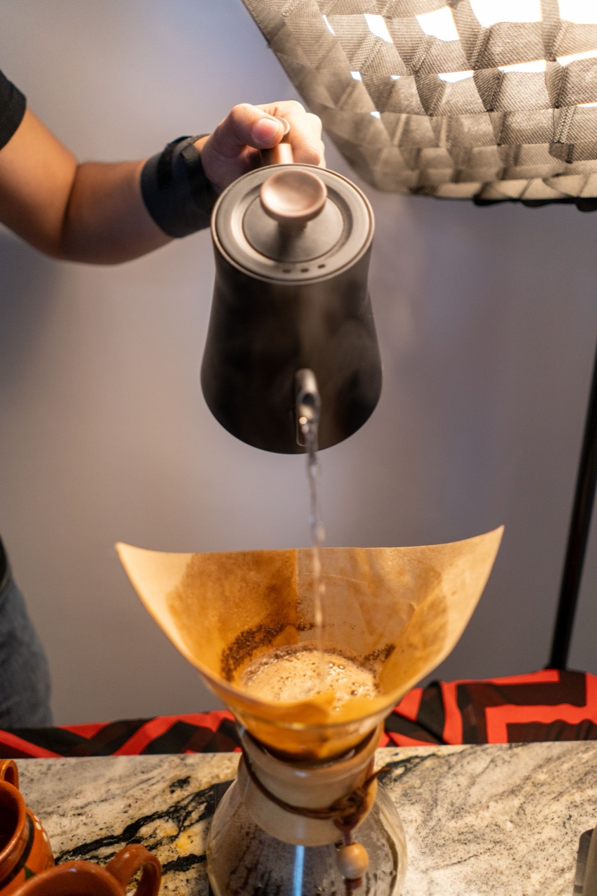 Pouring hot water over Kahoa coffee in a slow spiral